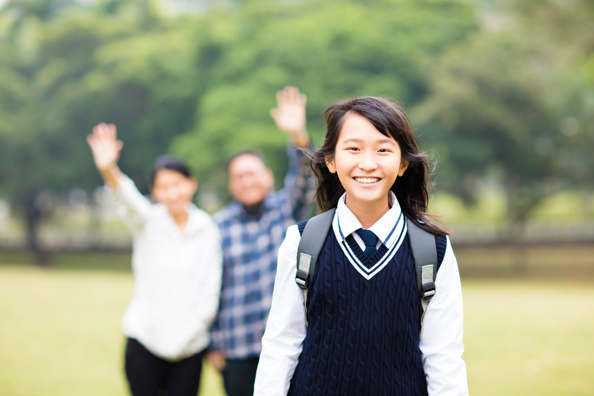 Image of cute young student girl with parent in school
